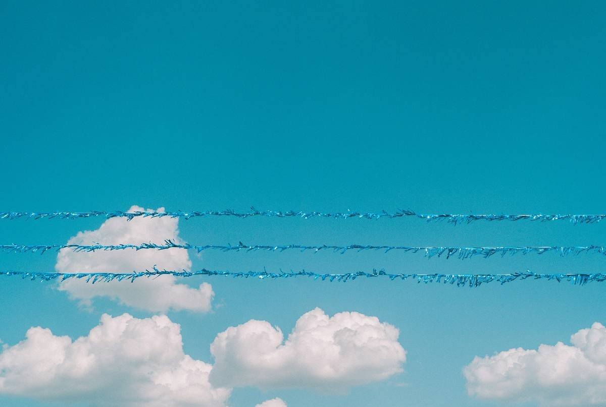 A group of airplanes flying through a blue sky