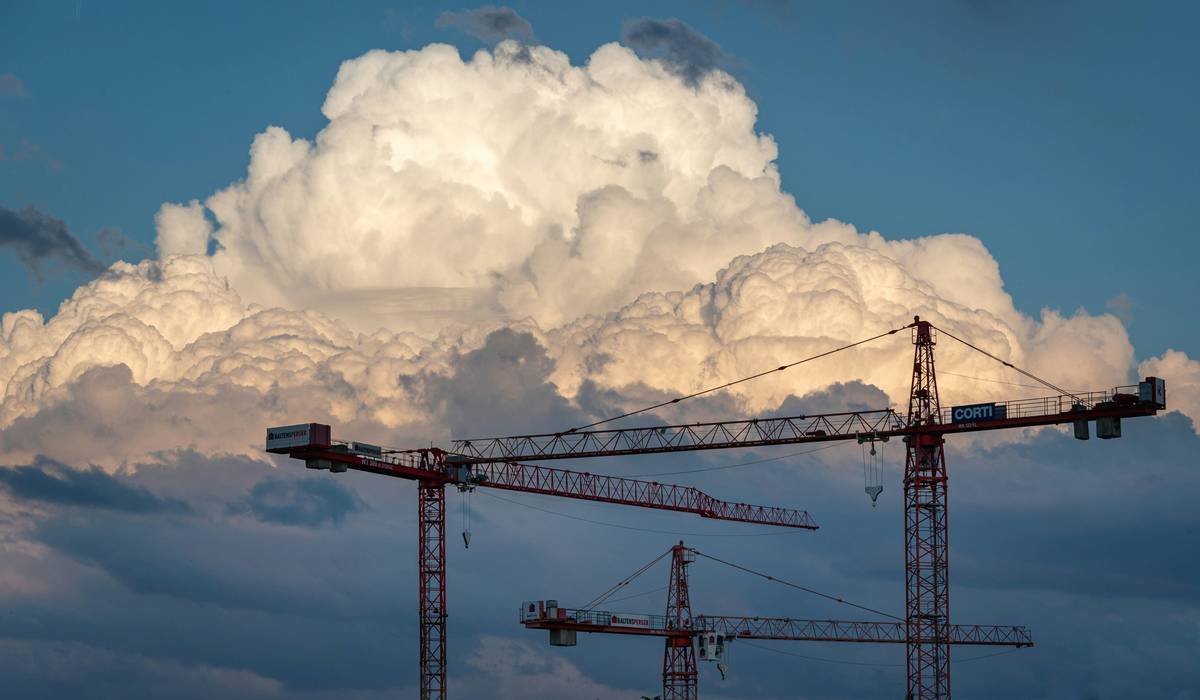 a large cloud looms over a construction site