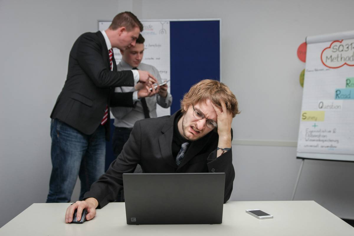 A man sitting in front of a laptop computer