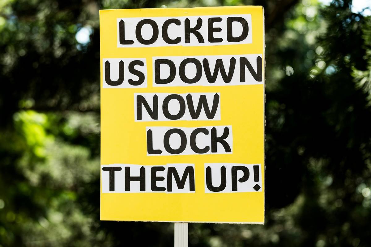 a yellow sign that says locked us down now look them up