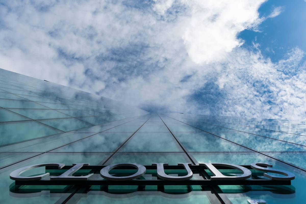 Clouds text on prime tower skyscraper, scraping the clouds