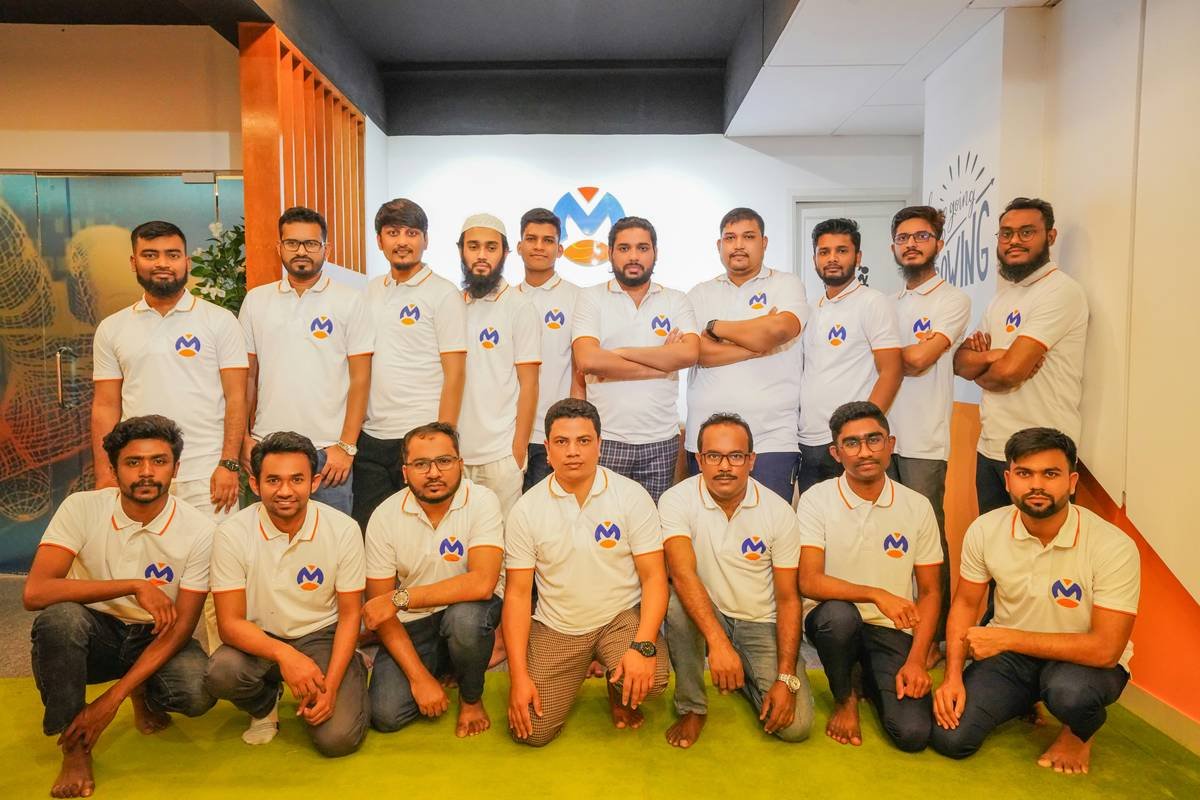 A group of men in white shirts posing for a picture