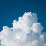 a large cloud in the blue sky