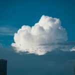 A cloud is in the sky over a city
